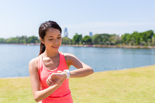 Woman using smart watch at park