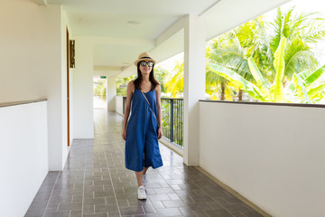 Asian woman walking in corridor of resort