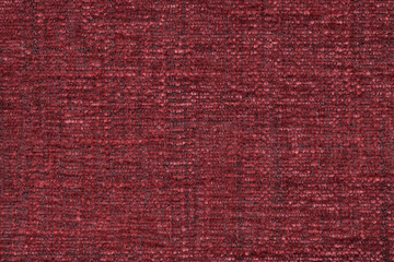 Red fluffy background of soft, fleecy cloth. Texture of textile closeup
