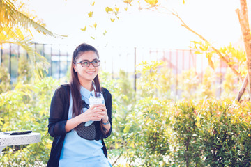Young woman with coffee in garden