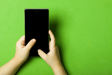 smart phone in the hands of a child