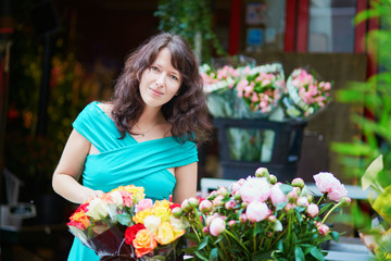 French woman choosing flowers on market
