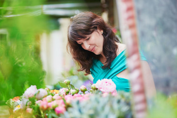 French woman choosing flowers on market