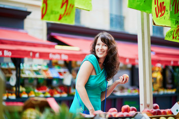 French woman choosing fruits on market