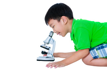 Asian child observed through a microscope biological preparations.