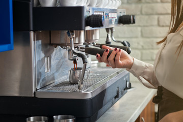barista is preparing coffee on coffee machine