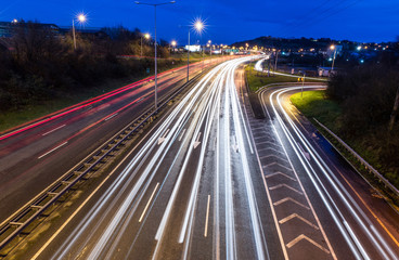 Fototapeta na wymiar Light trails on highway during evening rush hour