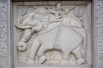 Stone bas relief of elephants in buddhists' temple