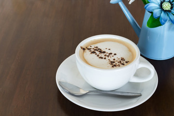 Hot cappuccino on wood table in coffee shop
