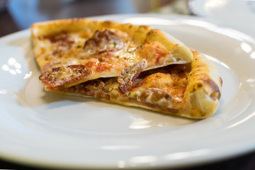 Fresh Hot Pizza with Pepperoni Sausage and Mozzarella Cheese Sprinkled with Herbs