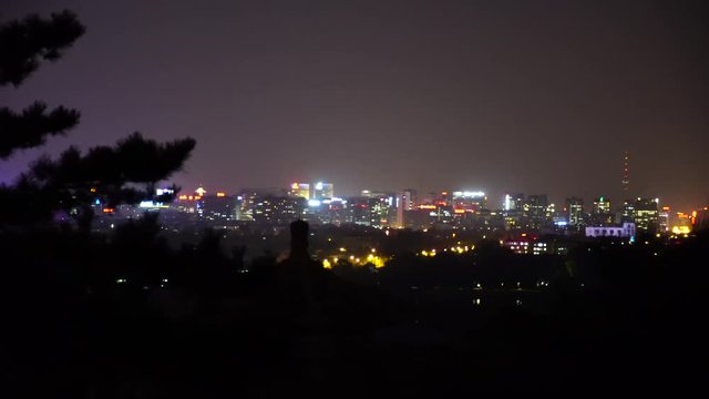 Night view of the city, city lights on the horizon. View from the hill.
