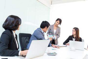 Business partners discussing documents and ideas at meeting