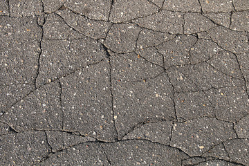 Texture of the cracked asphalt.