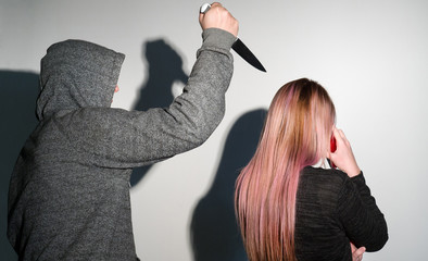Robbery stalking a woman and holding a knife © yakub88