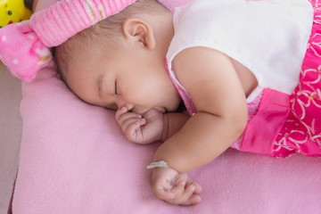 portrait of baby sleep and sucking finger.