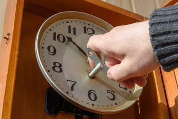 A man winds up a mechanical watch
