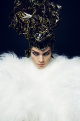 Woman in headwear and fur coat 