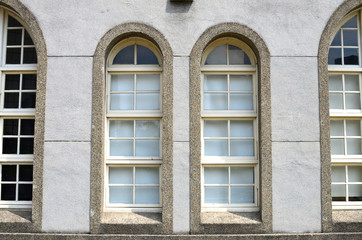 Wall of an old building with arch windows.