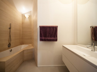 Bathtub with marble tiles on the walls