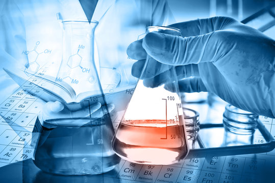 Flask in scientist hand with laboratory background 