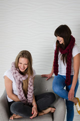 Two friends in merino wool scarfs having fun