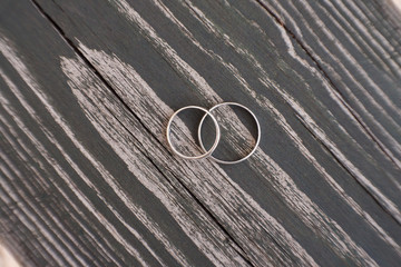 two wedding rings on impressive a wooden table. Wedding concept