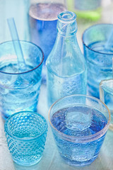 Blue bottles and glasses with drinks 