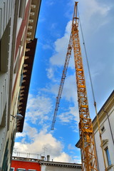 Fototapeta na wymiar The yellow crane in the blue sky.
