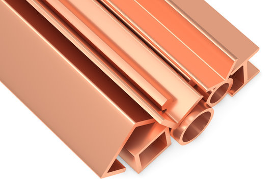 Shiny rolled copper metal products on white closeup