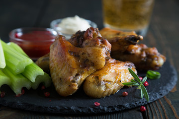 Fried chicken wings with celery and beer