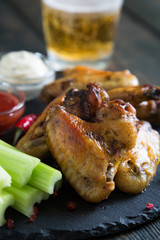 Fried chicken wings with celery and beer