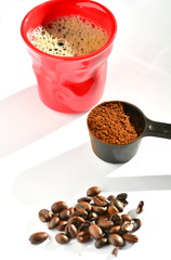 Coffee beans, powder and red cup.