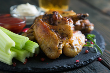 Fried chicken wings with celery and beer