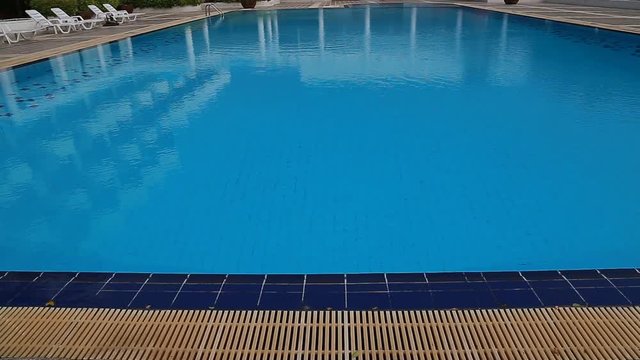 Hotel swimming pool with sunny reflections