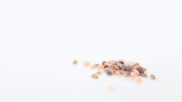 A Few Small Rough Natural Stones on a White Background
