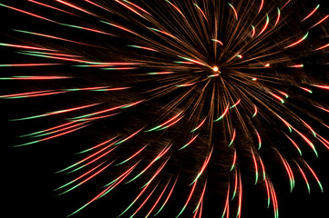 big red and green firework on black background