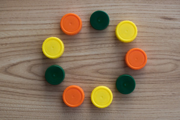 Circle of multicolored plastic closures