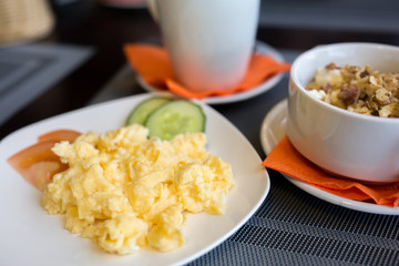 Traditional breakfast with scrambled eggs, cottage cheese and coffee
