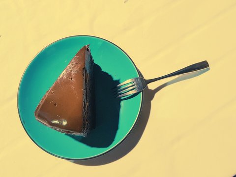 Chocolate cake pastel dish on yellow background