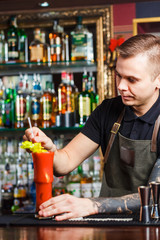 The bartender making cocktail