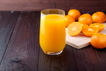 Orange juice on wooden background