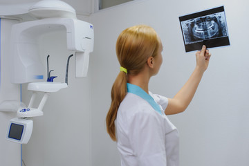 dentist analyzes a dental panoramic x-ray film