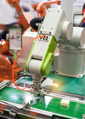 Automatic robot in assembly line working in factory. Smart factory industry 4.0 concept.