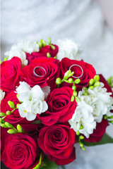 wedding rings on wedding bouquet