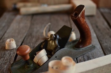 Old carpentry tools hammer, chisel, plane on an old board