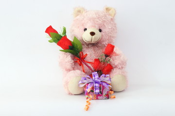 Teddy bears, pink and red roses and gift box on a white background.
