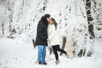 Fototapeta na wymiar couple lovers kiss winter street forest. Couple love