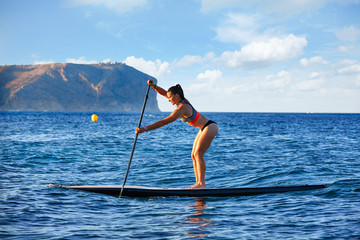SUP Stand up Surf girl with paddle