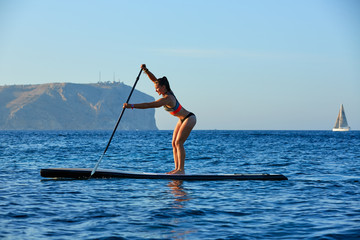 SUP Stand up Surf girl with paddle