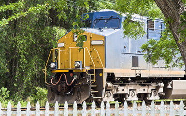 Locomotive train engine runs through someone's backyard.